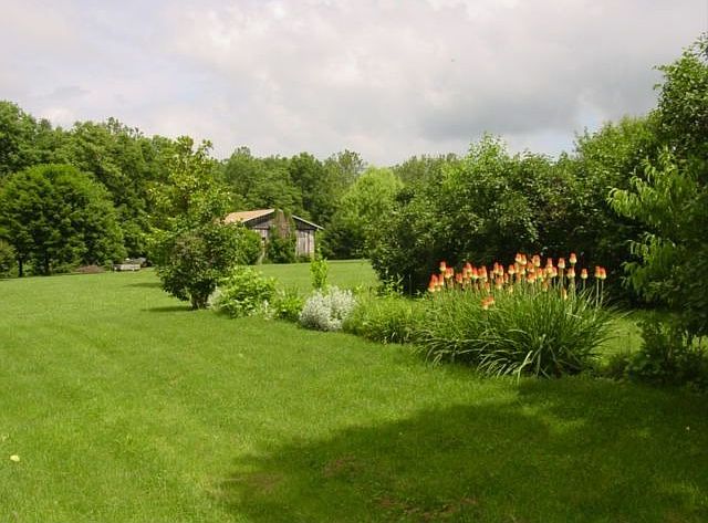 Flower gardens w/ view to pole barn