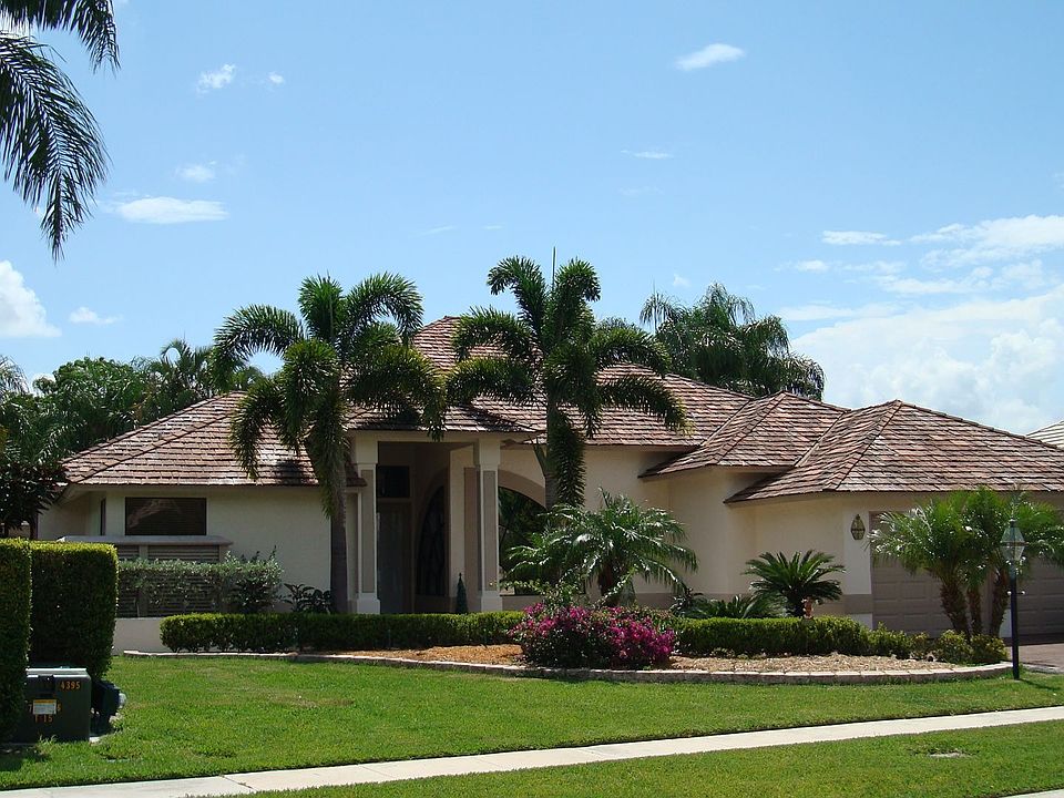 Nearly 1/4 acre lot with beautiful palm trees await your arrival