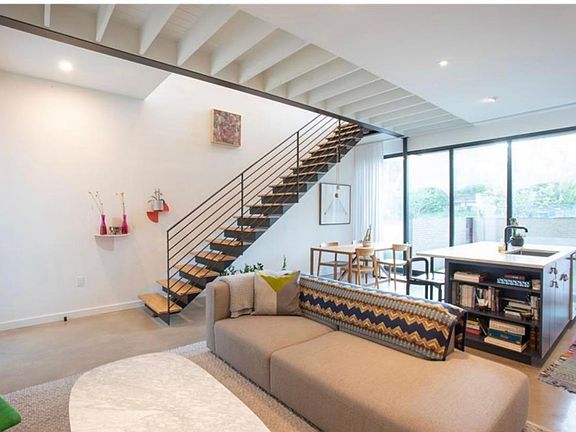 Downstairs living space and floating stairs to 2nd floor.