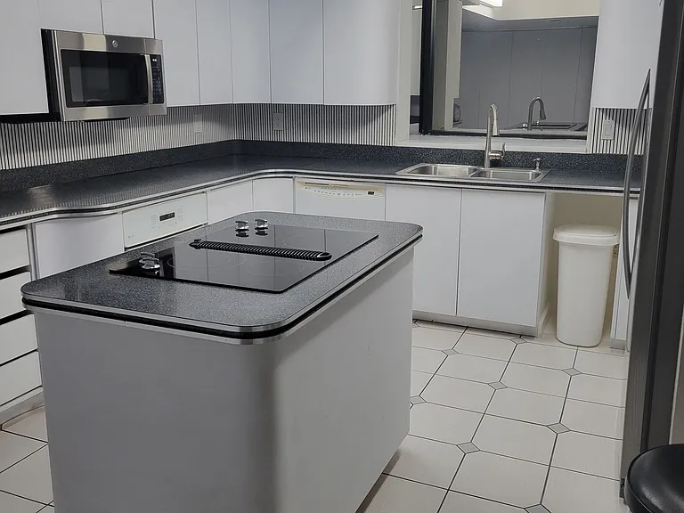 Light and bright kitchen with abundant cabinet storage including a whole wall pantry!