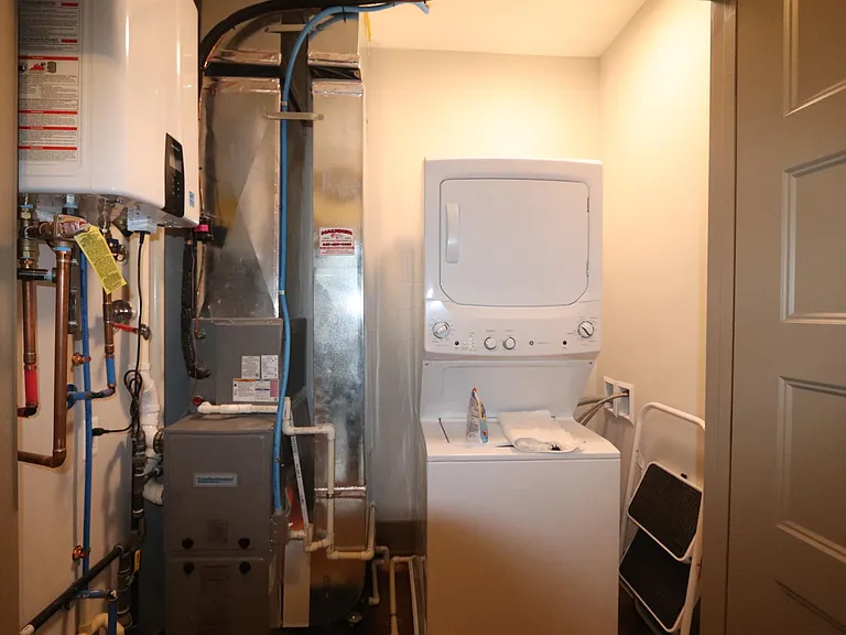 Laundry and utility room. Tankless water heater