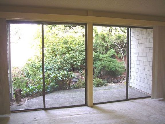 Double sliding glass doors bring plenty of light into the living room. Be crea