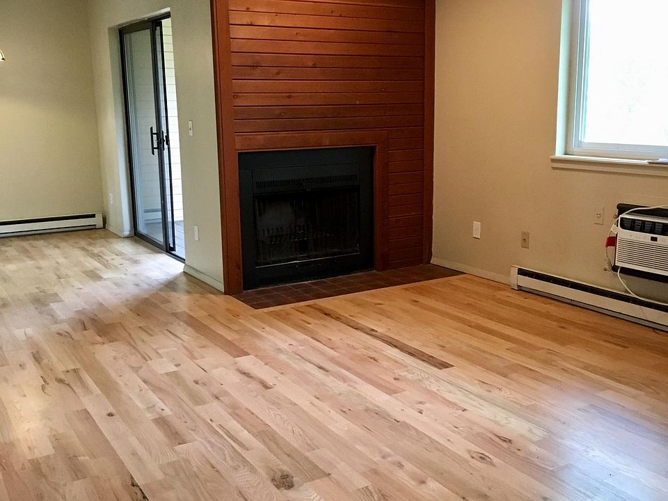 Main common area showing balcony access, fireplace, and A/C.