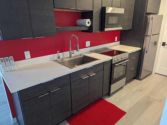 Deep stainless steel sink and solid surface countertops