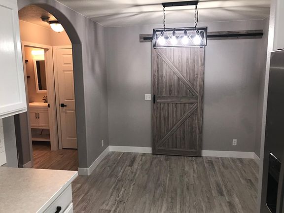 Dining area, laundry behind barn door.