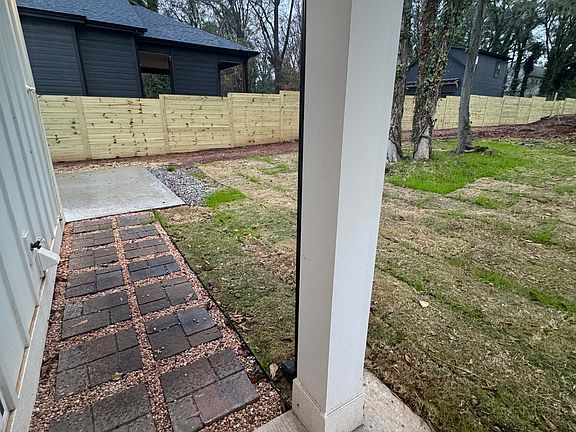 Stone pathway to the driveway and newly sodded back yard.
