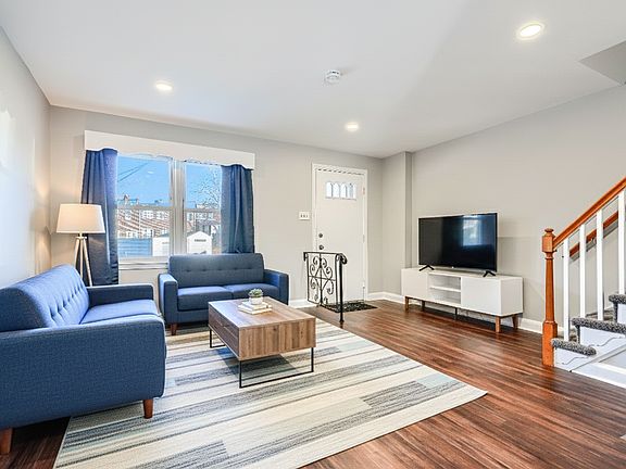 Enter into the family room, freshly finished with beautiful paint and flooring.