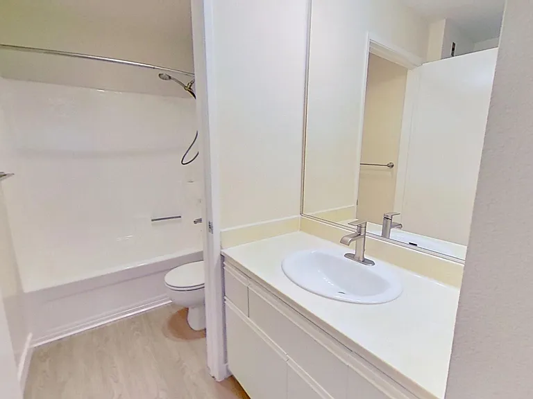 Vanity and en-suite bathroom in second bedroom of apartment #213