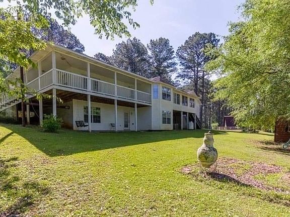 rear view of the house. Walkout basement with a covered porch area with a swing to enjoy the outside view