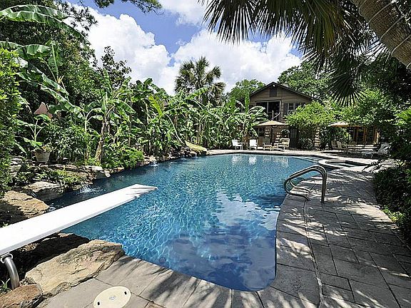 Resort style pool with lagoon bottom, spa, slide, diving board and waterfalls.