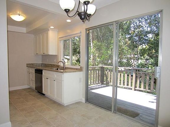 Remodeled kitchen with tile floor and eating area