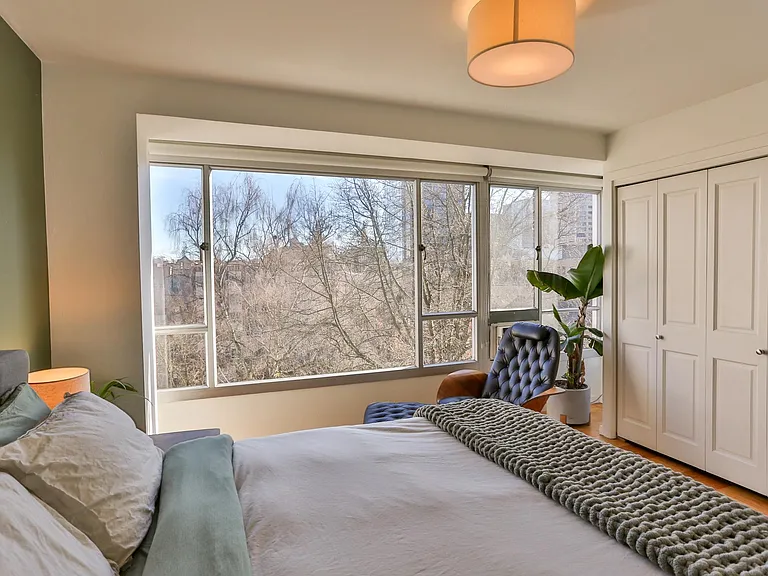 The bedroom is generously sized and includes a a queen-sized memory foam bed, beautiful original mid century furniture, and a full wall closet.