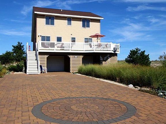 Stunning custom paver driveway provides gracious entry.