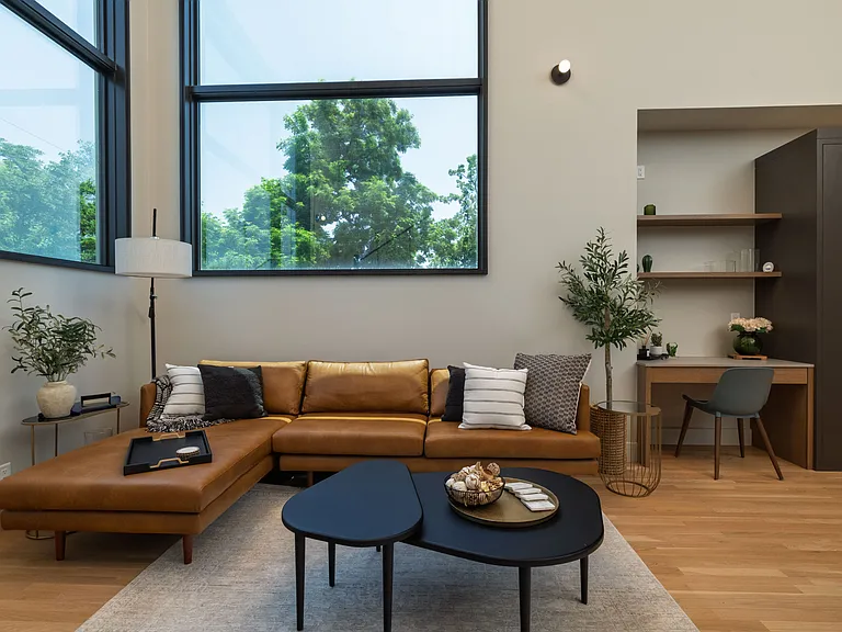 Open concept living room with lots of seating and natural light from the 2 large windows.
