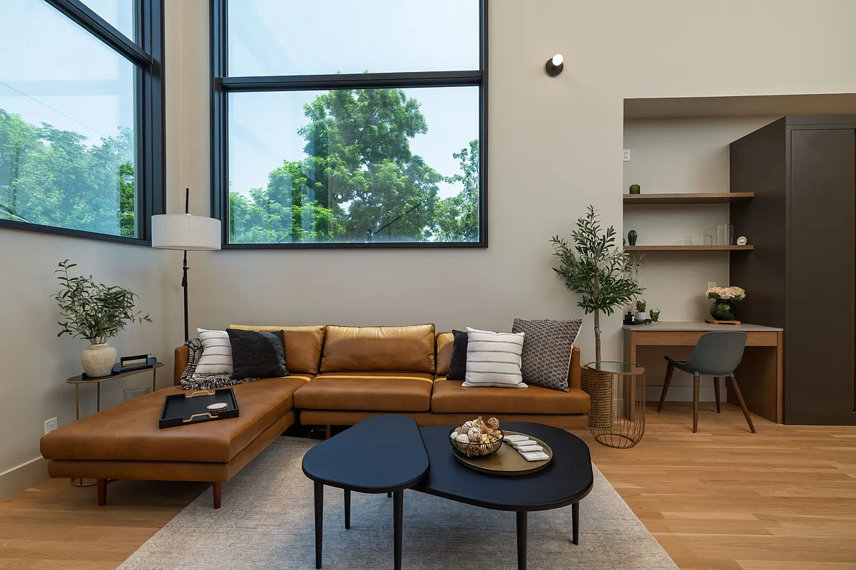 Open concept living room with lots of seating and natural light from the 2 large windows. - 1211 6th Ave #201