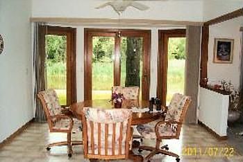 Dining room also faces canal and has bay-shaped doorwall leading to deck.