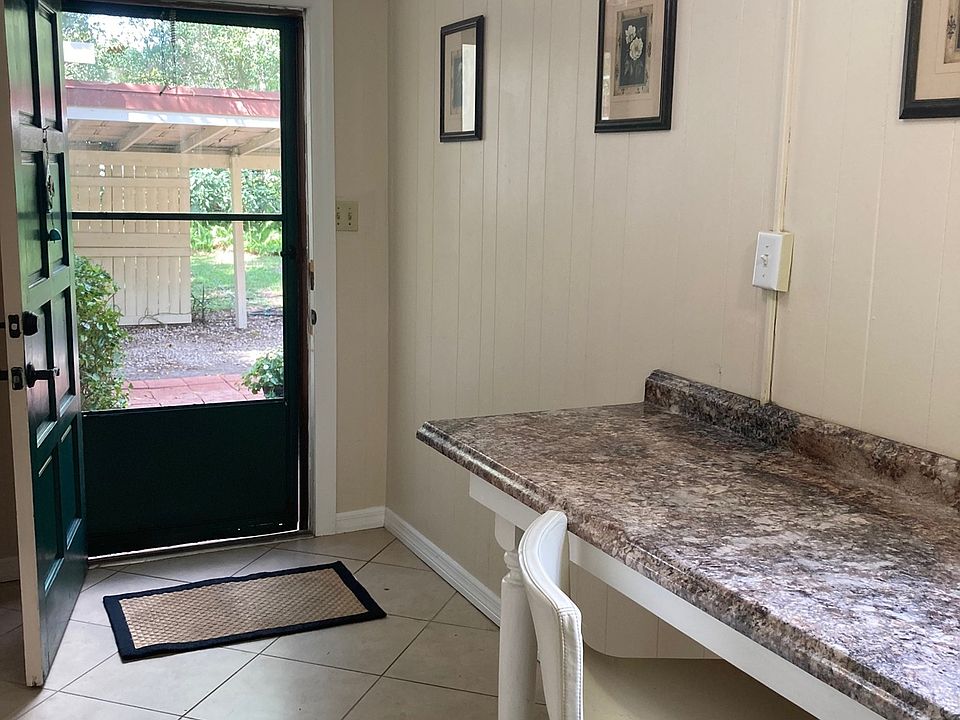 Looking out the door from the bar area into the courtyard with private one-car carport steps from the front door.
