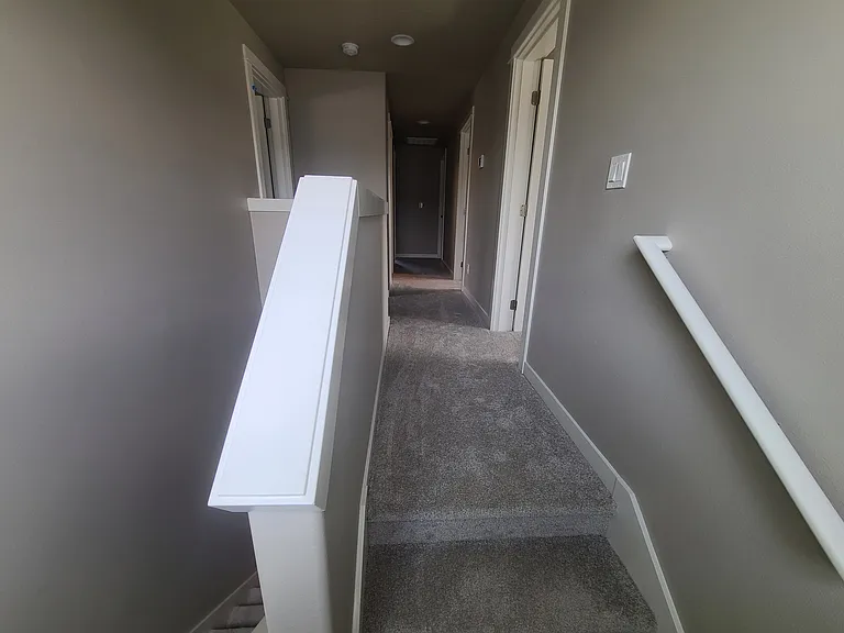 Top of stairs, viewing upstairs hallway
