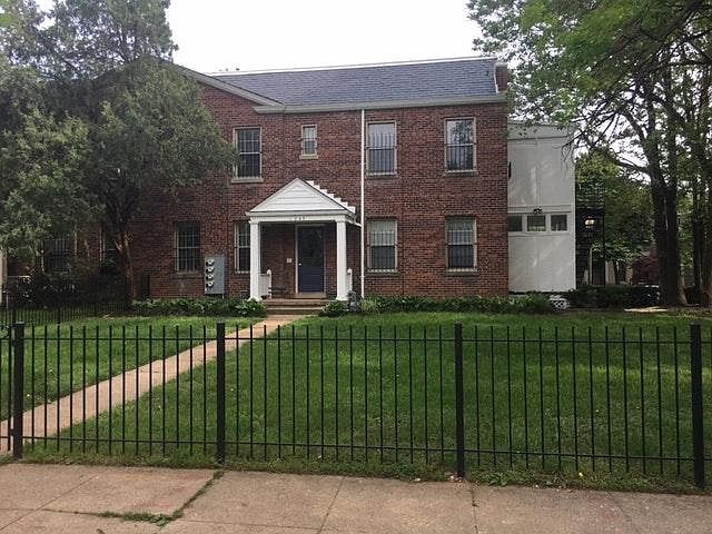 Exterior front yard with wrought iron fence