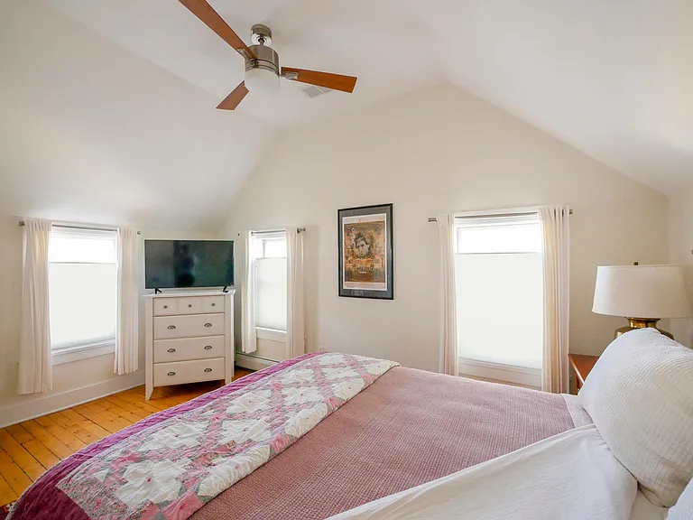 2nd floor: Master bedroom includes dresser and and a 40" smart TV.