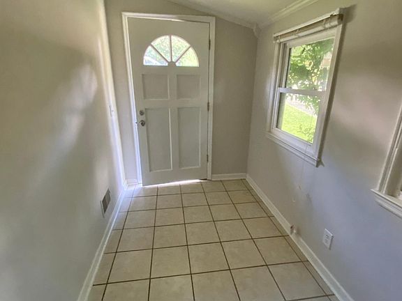 Tiled entry foyer perfect to drop keys and mail