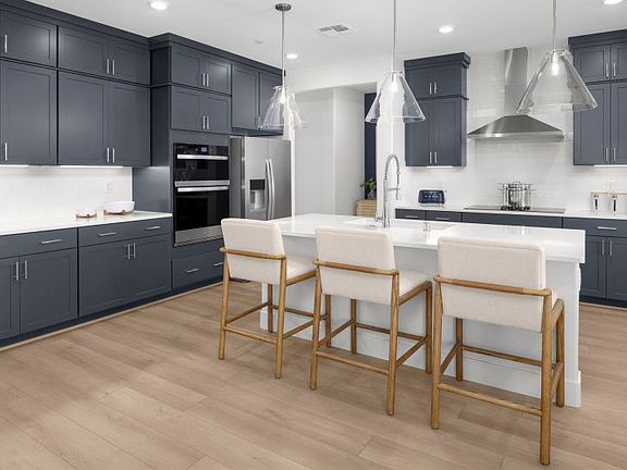 Kitchen with large central island and chef s appliance package