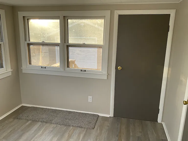Rear entrance to home, goes thru 3 season room. All freshly painted and new flooring