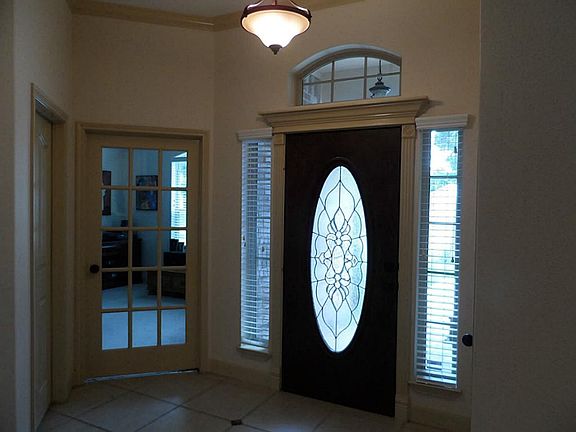Welcoming foyer area. Gorgeous front door with crown molding!