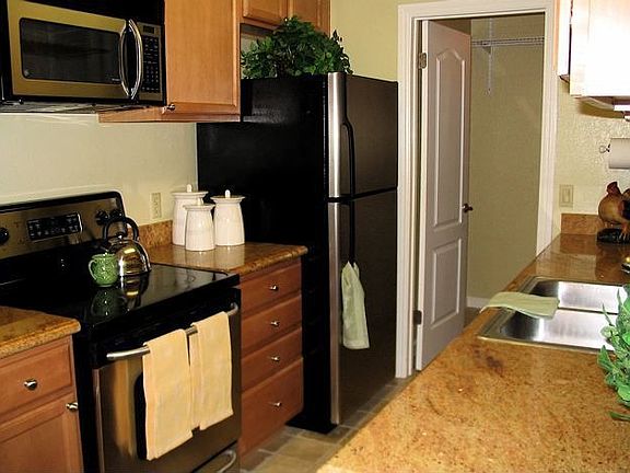 Kitchen with stainless steel appliances and separate washer and dryer room