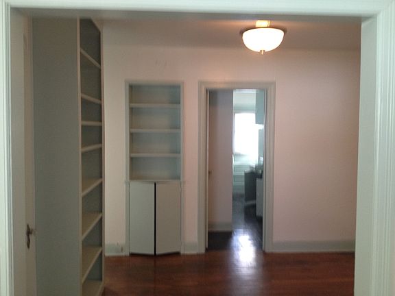 Dining room with view of galley kitchen with back door