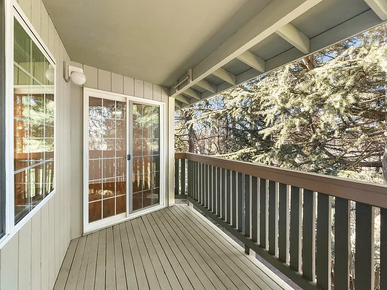 Relax on your private balcony with peaceful wooded views