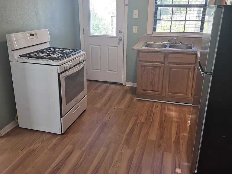 Dining area through kitchen, back door closed.