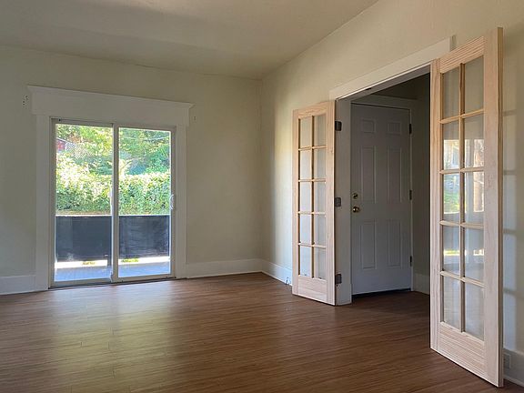 Living room with a view of the porch and front entrance hallway.