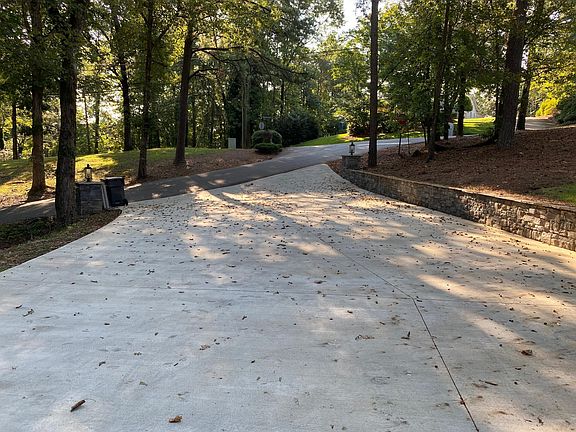 New double driveway with beautiful stone retainer wall.