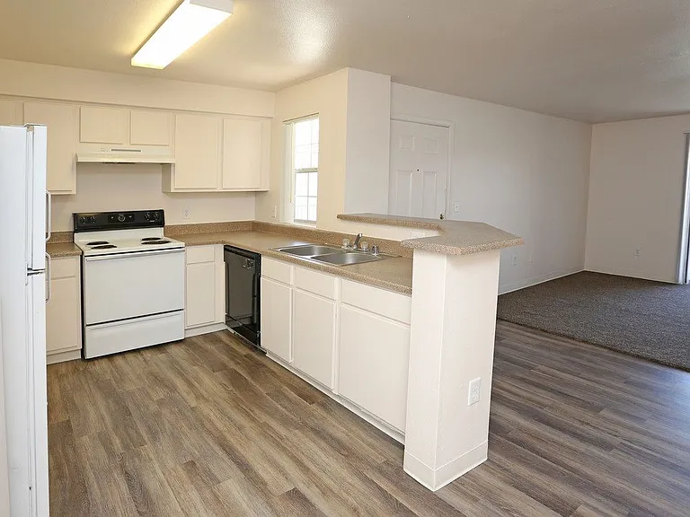 Open kitchen with white appliances