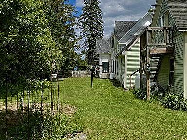 Back/Side yard with stairs and entrance deck to studio.