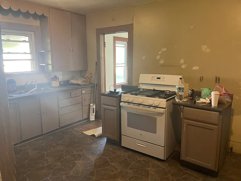 spacious Kitchen, newer stove. About to get fresh paint! Fridge not provided.