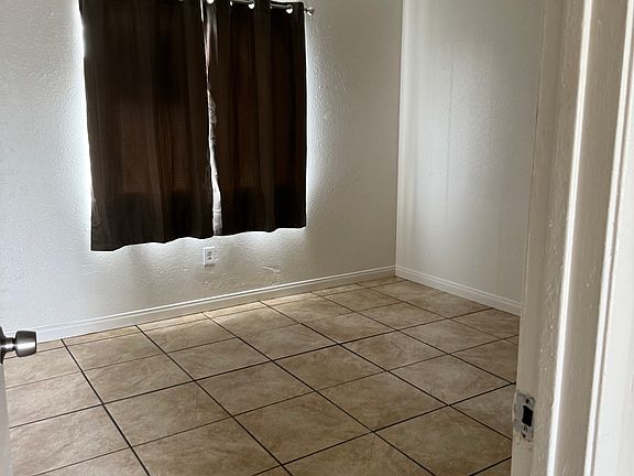 Bedroom on right newly painted walls along with new flooring and baseboards and new window dressings.