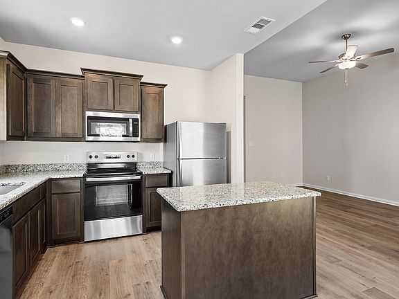 The kitchen has beautiful wood cabinetry.