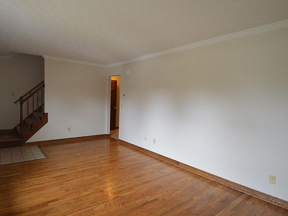 Wood floors with tile entry in the living room.