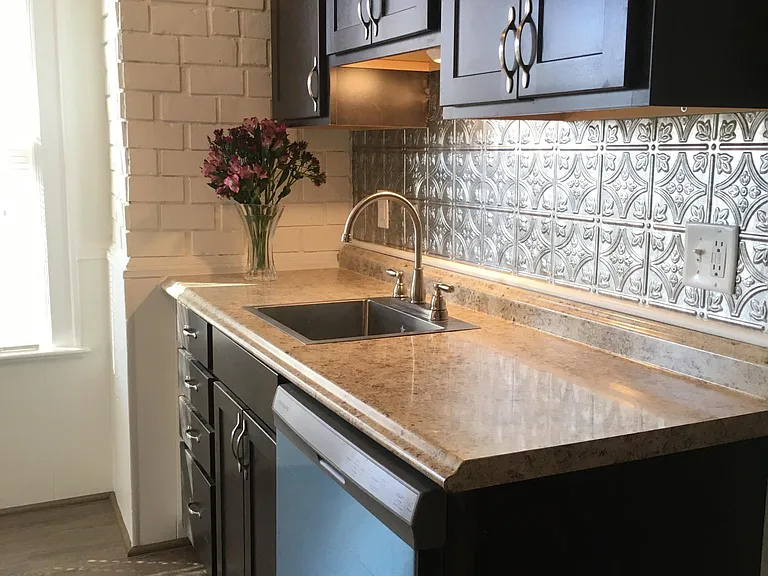 Fully renovated kitchen complete with dishwasher, oven and fridge. Custom built cabinets. New windows and flooring.