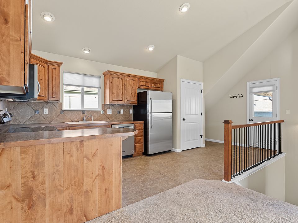 Kitchen, Stack Washer/Dryer (in closet) & Covered Patio Access