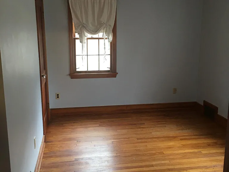 bedroom at south end of house facing the side of the house and front yard (9' x 13')