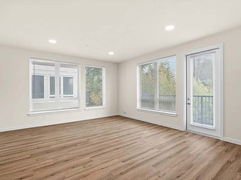 Bright living room with oversized windows and direct balcony access. Bright living room with oversized windows and direct balcony access.