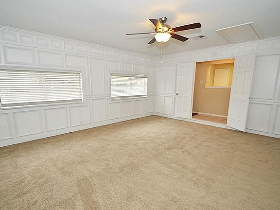 The double doors off the entry lead to huge game room or living room. Use it as additional bedroom i