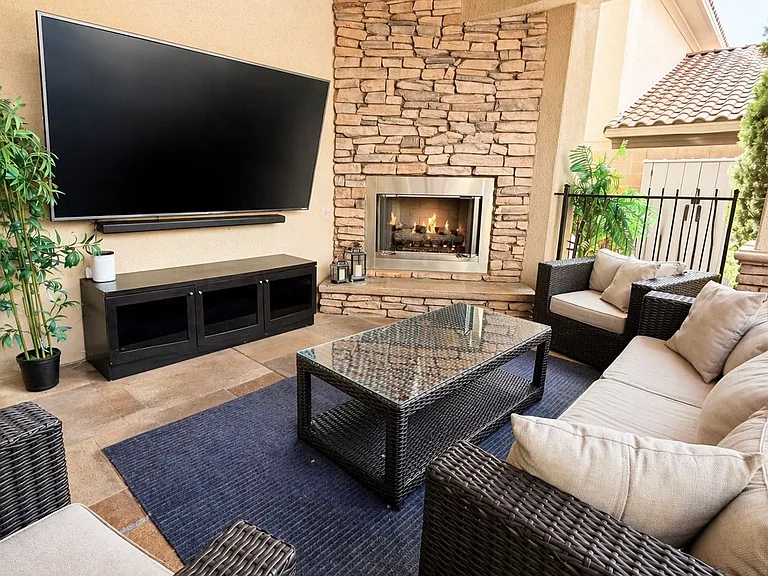 Outdoor covered media area with gas fireplace