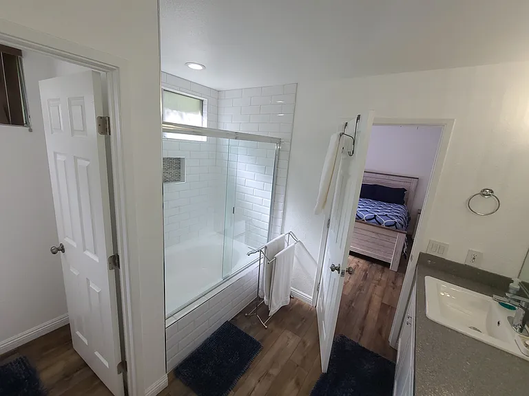 Retreat and recharge_this main bathroom features dual sinks and a spacious soaking tub, perfect for unwinding after a long day on the greens. ___