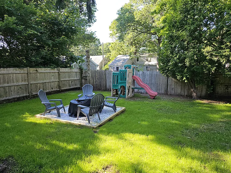 Large private back yard with fire pit.