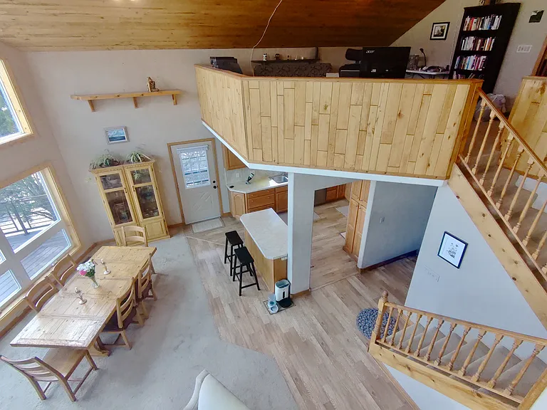 Great room with kitchen underneath office loft