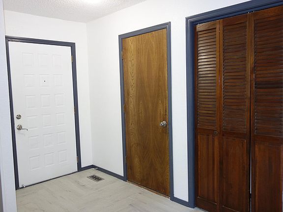 Just inside the front door. Garage access through the wood door and coat closet behind the bi-fold doors.